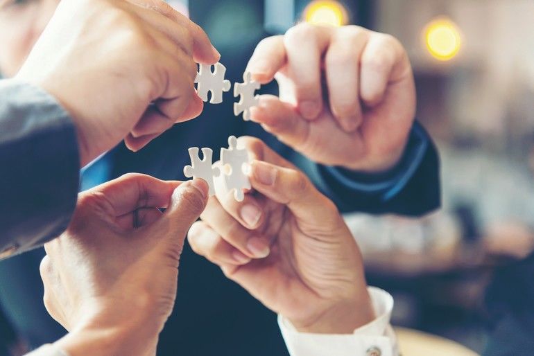 Creative Partner Businessman_team_work_holding_two_jigsaw_connecting_couple_puzzle_piece_for_matching_to_goals_target,_success_and_start_up_new_project_in_office,_select_focus._Business_Concept.