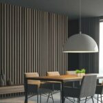 Dekore Pfleiderer Corner_of_stylish_dining_room_with_gray_and_dark_wooden_walls,_concrete_floor,_panoramic_window,_long_table_with_comfortable_chairs_and_massive_lamp._3d_rendering