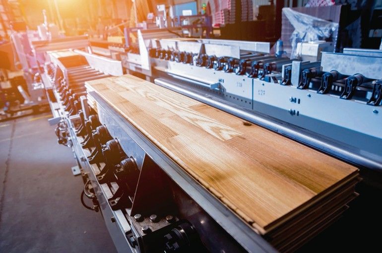 Production_line_of_the_wooden_floor_factory._CNC_automatic_woodworking_machine._Industrial_background_Production_line_of_the_wooden_floor_factory._CNC_automatic_woodworking_machine._Industrial_background